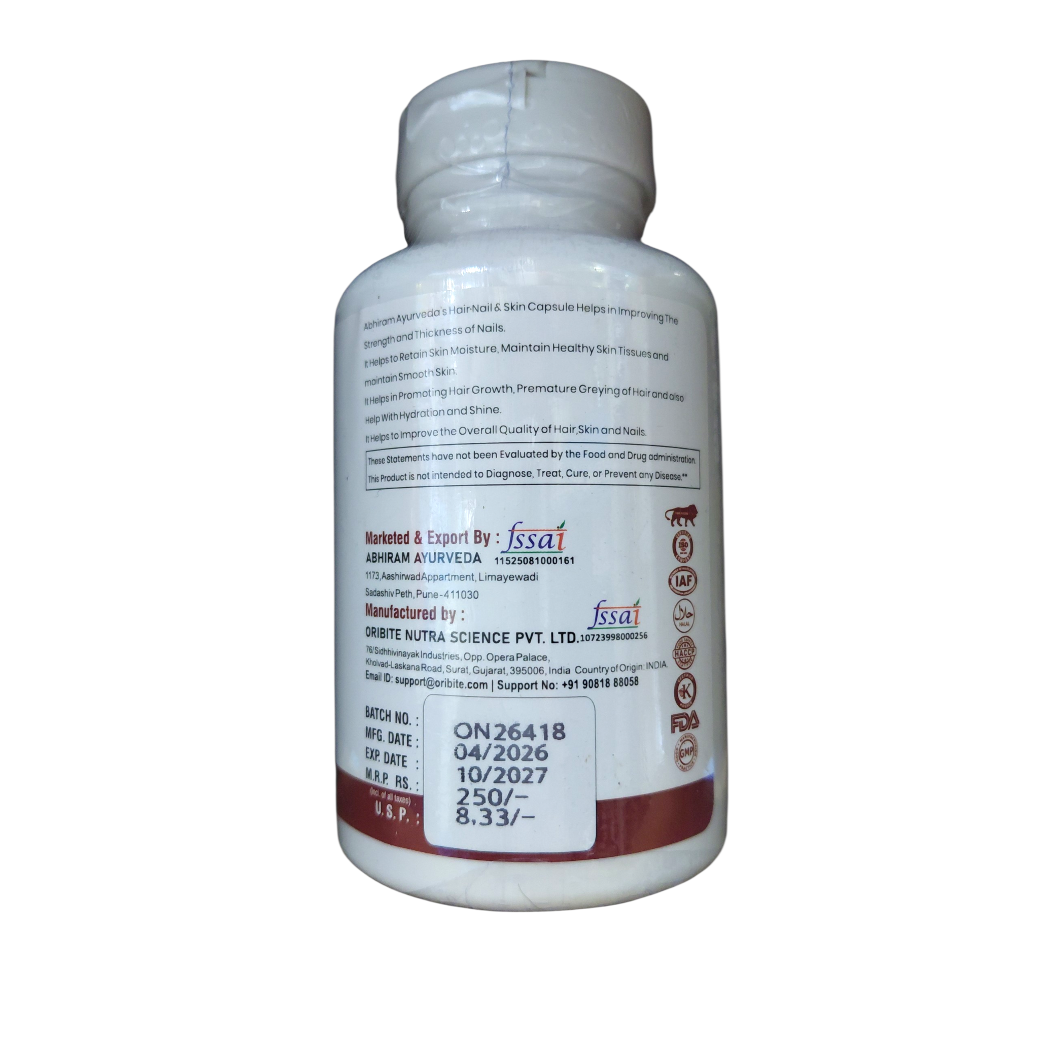 Abhiram Ayurveda Hair, Nail & Skin Supplement bottle with capsules, natural herbal health product for beauty and wellness.